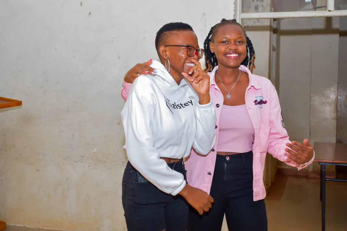 Two Zinduka Hub community members sharing a laugh